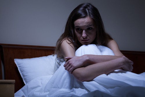 what is adrenal health - woman having sleepless night in bed