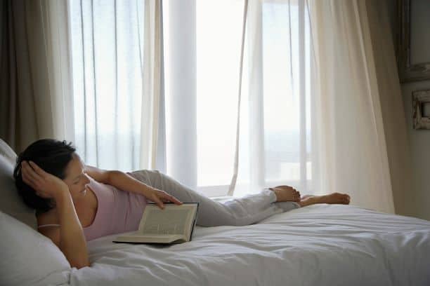 book stand for reading - woman reading in bed