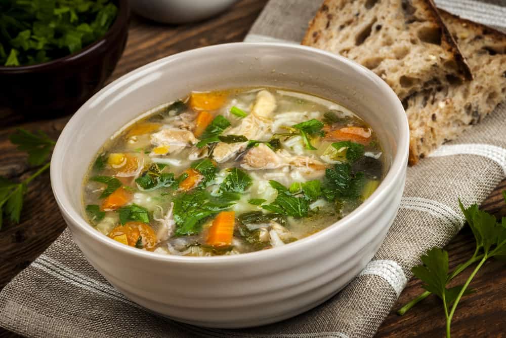 bowl of vegetable soup with bread